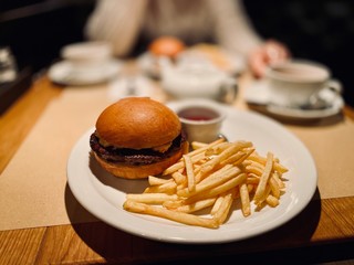 cheeseburger and fries in a cafe