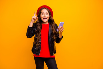 Portrait of her she nice attractive trendy cheerful cheery long-haired girl wearing streetstyle using cell creating smm isolated over bright vivid shine vibrant yellow color background