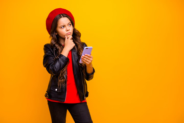 Portrait of her she nice attractive trendy bewildered long-haired girl wearing streetstyle using cell creating new post isolated over bright vivid shine vibrant yellow color background