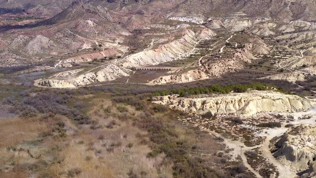 The aerial view of the rock mountain terrains in Cascada Pantano Elche in Spain