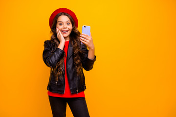 Portrait of her she nice attractive delighted cheerful excited long-haired girl wearing streetstyle using cell modern digital technology isolated over bright vivid shine vibrant yellow color