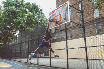 Basketball player making a huge slam dunk