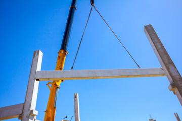 Mobile crane is carry concrete joist to assembly huge hall