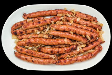 Barbecued Gourmet Hot Sausages Served with Minced Onion on White Oblong Porcelain Tray Isolated on Black Background