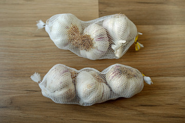 packaged garlic on wooden background