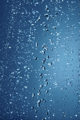 Naklejka na ściany i meble Falling water drops in frozen motion.