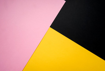 Minimalist concept, abstract colored paper geometry background, flat lay top view, multicolored empty image with copy space for any design purposes, bright yellow, bright pink, simple black