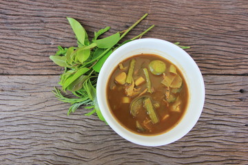 Tai Pla Curry, local food of the southern region.Thailand,Fish organs sour soup on the brown wooden.