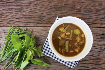 Tai Pla Curry, local food of the southern region.Thailand,Fish organs sour soup on the brown wooden.