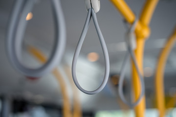 Handle hook in public bus/tram use for providing stability for passenger. Transportation and vehicle equipment object. Selected close focus.