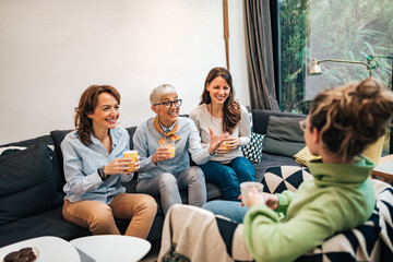 Family time. Four female members of the family spending fun time together at home.
