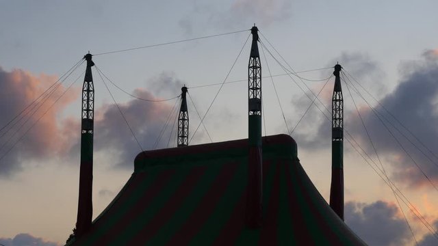 beautiful view at sunset. silhouette building roof against background sky towards evening. shadow big top circus clouds are moving across heaven. concept: holiday fun vacation live show tour.