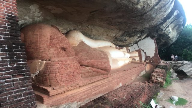 Sigiriya, Sri Lanka, November 23, 2019, Buddha in the rock with tourist 4K