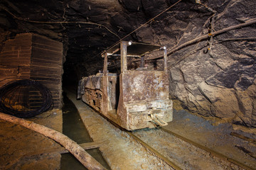Fototapeta na wymiar Underground gold mine shaft tunnel drift with electric locomotive