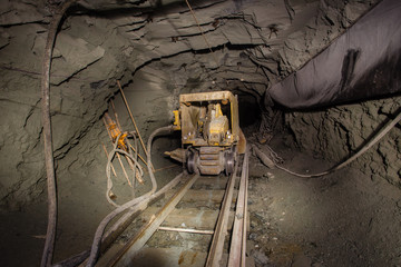 Naklejka premium Underground gold mine shaft tunnel drift with loading machine eimco