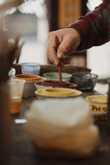 Craftsman decorates handmade terracotta