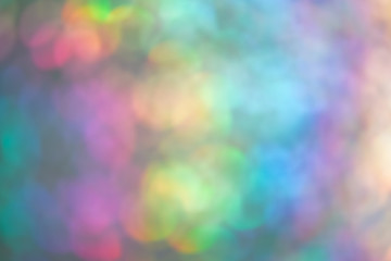 Abstract rainbow holographic glowing background, soft focus, bokeh.