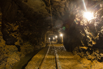 Naklejka premium Underground gold mine shaft tunnel drift with rails
