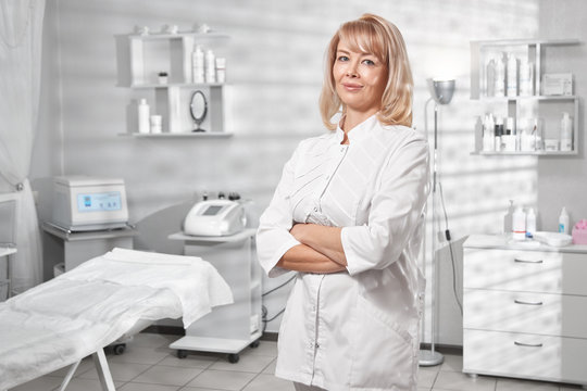 Portrait of successful professional doctor cosmetologist dermatologist woman in her beauty salon smiling in white medical clothes close-up