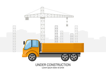 Building under construction with yellow truck in front