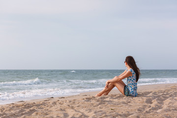 Fototapeta na wymiar Young woman by the sea.