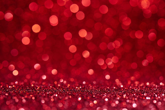 Red blurred abstract shiny valentines day background with bokeh effect, festive glitter sparkles