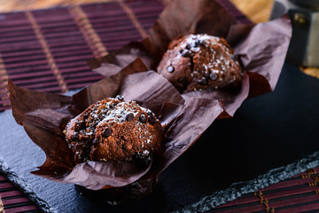 blueberry and chocolate muffins in paper cupcake holder