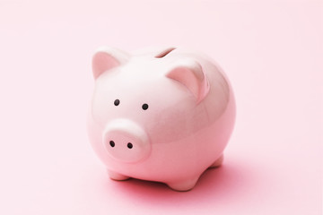 Piggy bank on a pink background, close-up
