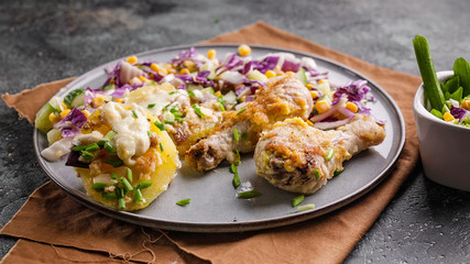 Food banner. Appetizing baked chicken legs with potatoes, cheese and red salad.