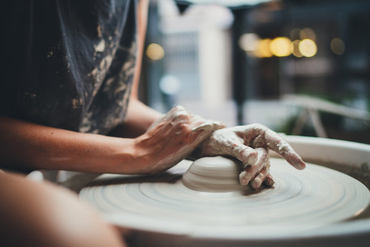 Side View of Young Creative Girl Student Makes her First Vase in a Pottery Class Sitting at a Pottery Wheel in a Cozy Workshop, Handcrafted Product Hobby Art