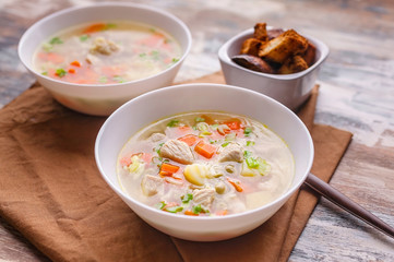Close up soup with turkey meat, potatoes, carrots, noodles and croutons. Homemade delicious dinner