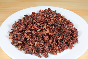 Plate of Cooked Rice-berry Rice Served on Wooden Table with Selective Focus