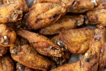 Close-up deep fried chicken wings with salt, Thai food.