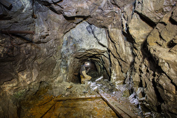 Underground gold mine shaft tunnel with miners