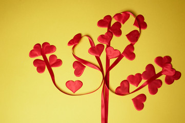 Valentine's day, a Declaration of love.Tree of love from a heart and a ribbon. Yellow background.