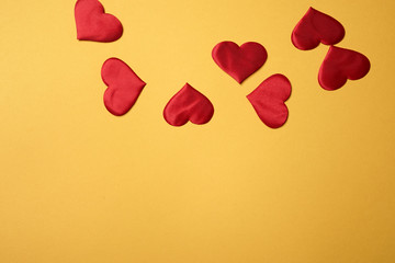 Valentine's day, a Declaration of love.A few red hearts on an orange background. Free space at the bottom.