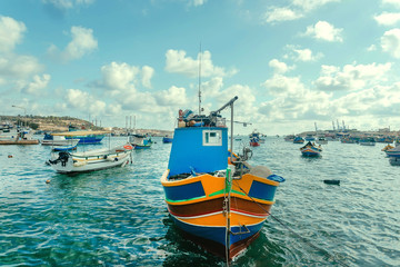 Fototapeta na wymiar Colorful harbor with fishermen boats under bright sun