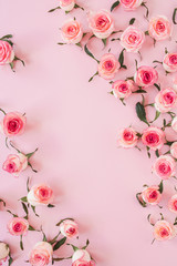 Floral composition with pink rose flower buds on pink background. Flat lay, top view.
