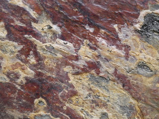 Stone wall texture in brown, red and white colors