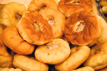 Traditional Asian cuisine – homemade round-shaped pastry filled with meat (selective focus)