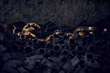 Large stack of many old rusty car parts with sunlight and shadow on  surface in dark tone style, reused and recycle concept
