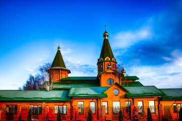 Orthodox wooden church at dawn. Temple of the Blessed Matrona of Moscow Soligorsk - obrazy, fototapety, plakaty