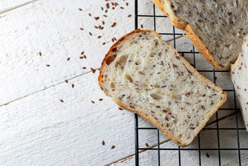 Homemade sourdough bread with flax seeds on a white wooden background. Baking without yeast.