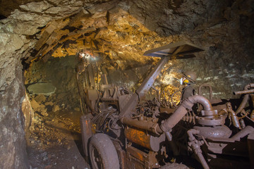 Fototapeta premium Underground gold bauxite mine shaft tunnel with drilling machine