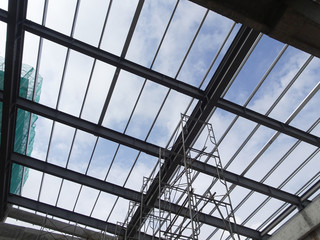 KUALA LUMPUR, MALAYSIA -JUNE 16, 2019: Lightweight roof trusses under construction at the construction site. Installed properly by workers to received the roof covering system. 