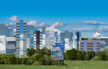 Fototapeta premium A modern cityscape of green energy and new glass houses and skyscrapers