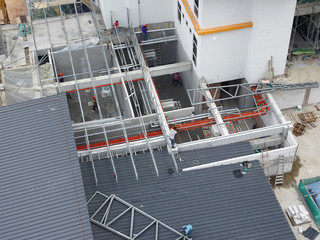 KUALA LUMPUR, MALAYSIA -JUNE 16, 2019: Lightweight roof trusses under construction at the construction site. Installed properly by workers to received the roof covering system. 