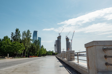 Fototapeta premium Construction of high-rise buildings in Baku. View from the waterfront.
