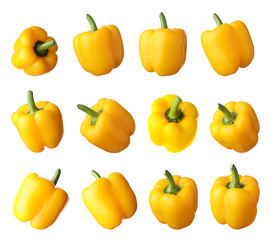 Set of ripe yellow bell peppers on white background