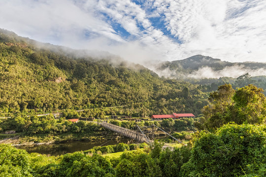 New Zealand, Abandoned Brunner Mine surrounded by green forested hills